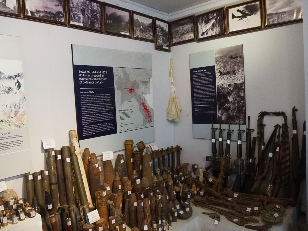 Museum display showing information panels and various ordinance's dropped on Laos